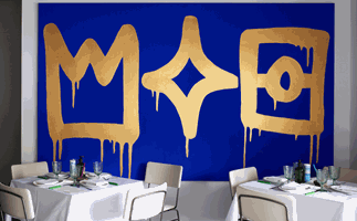 Di Stasio Carlton, Melbourne restaurant dining room with blue and gold artwork and crisp white furniture