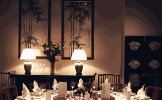 Flower Drum restaurant in Melbourne, dining room with large round table and dim lighting
